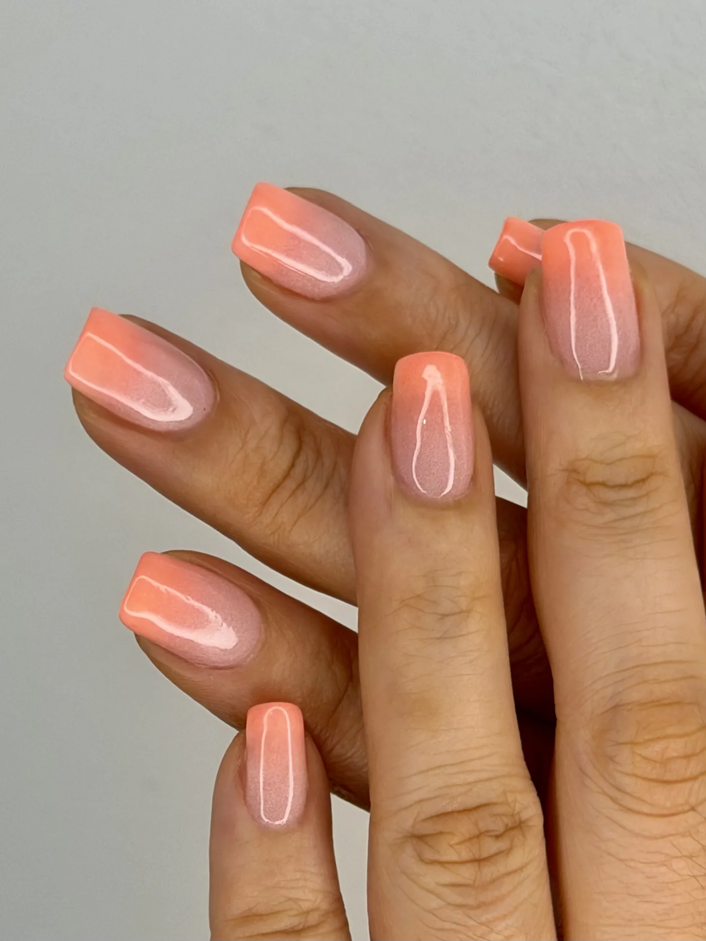 Glossy coral gel manicure at Mimosa Beauty Lounge, Barsha Heights Dubai