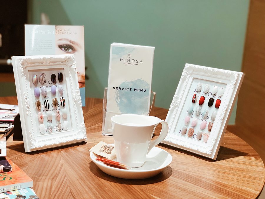 Nail art colour samples and the Mimosa service menu at the salon in TECOM, Barsha Heights, Dubai